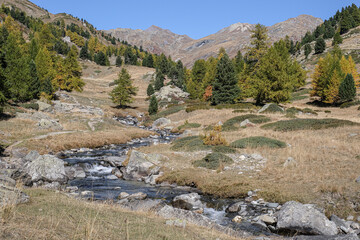 View of Claree river in Claree valley with Massif de Cerces mountains on either site, near Navache village and Briancon, Hautes-Alpes department, France
