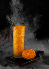 Orange juice in dark background. Conceptual photography. Healthy drink.