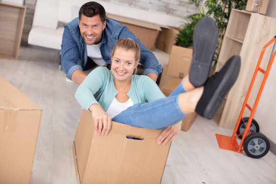 couple having fun with card board boxes at home