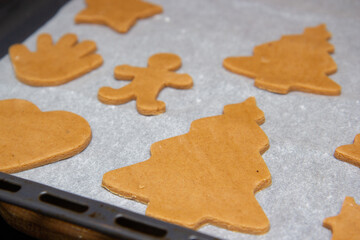 christmas gingerbread on a white parchment on a baking sheet