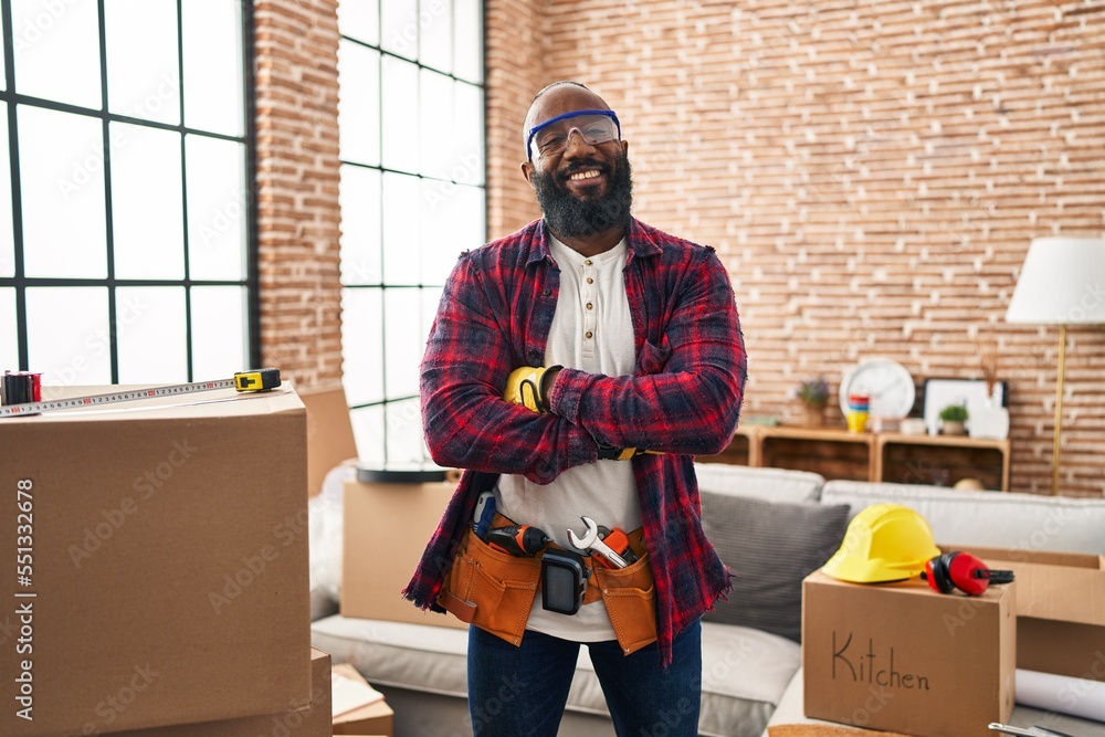 Sticker african american man working at home renovation happy face smiling with crossed arms looking at the 