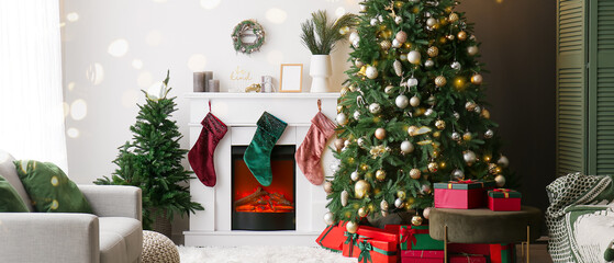 Interior of light living room with electric fireplace and Christmas trees
