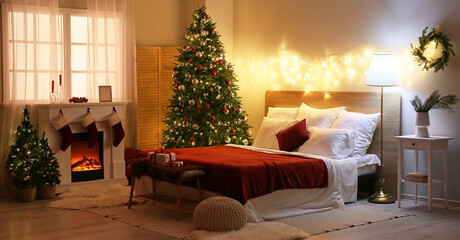Interior of bedroom with glowing lights, Christmas trees and fireplace