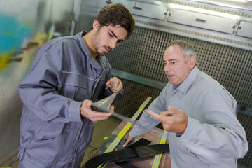 plumbing apprentice showing something to mentor