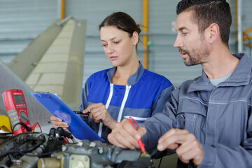 two mechanics discussing list of works