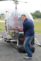 a pilot checking the helicopter