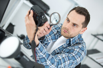 man with magnifier on camera