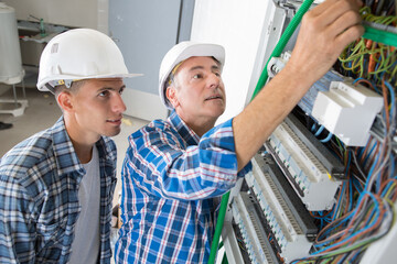 young apprentice electrician with mentor