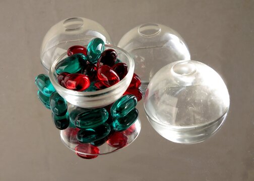 abstractive arrangement of glass objects,multicolor transparent capsules,light and reflex