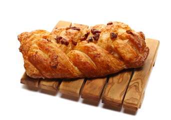 Fresh baked pecan bun isolated on white, side view