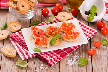 Friselle with cherry tomatoes and basil.