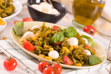 Fusilli pasta with cherry tomatoes and sweet corn.
