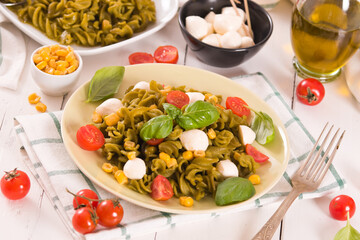 Fusilli pasta with cherry tomatoes and sweet corn.