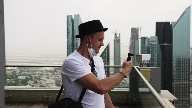 Man using light meter on skyscraper in Dubai