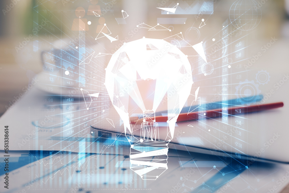 Poster Computer on desktop in office with bulb icon hologram. Double exposure. Concept of idea.
