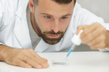 smart scientist man tests liquid substance in test tube