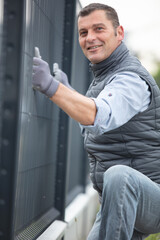 man fixing a fence outdoors