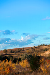 Beautiful mountain landscape. Mountains in the rays of the setting sun, in autumn.Green forest. Blue sky with beautiful clouds. park. Russia.	
