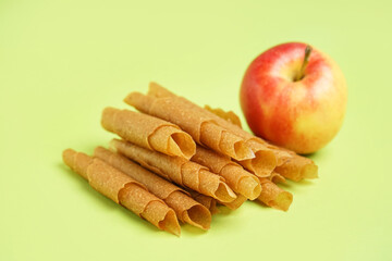 Heap of tasty apple pastilles on green background