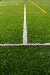 Obraz premium Close-up of white lines painted on artificial grass soccer field