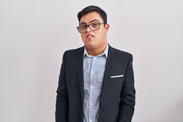 Young hispanic man with down syndrome wearing business style relaxed with serious expression on face. simple and natural looking at the camera.