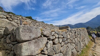 Machu Picchu is a 15th-century Inca citadel located in southern Peru on a 2,430-meter (7,970 ft) mountain ridge. It is located within Urubamba Province above the Sacred Valley, northwest of Cusco.