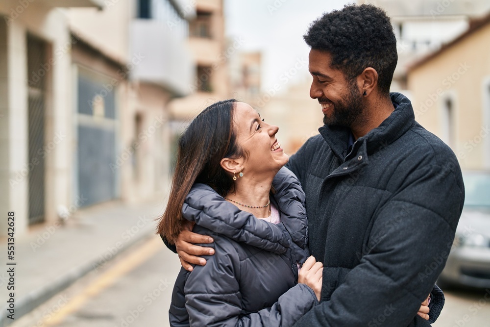 Canvas Prints Man and woman couple smiling confident hugging each other at street