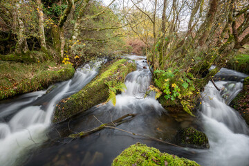 Long exposure of a waterfall on the Weir Water river at Robbers Bridge in Exmoor National Park