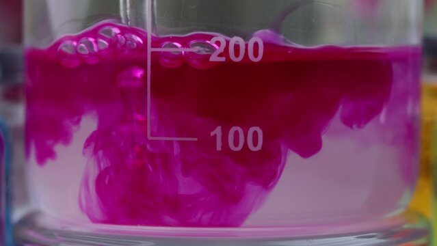 A beautiful chemical process of coloring an alkaline solution of sodium carbonate with the indicator dye phenolphthalein in purple color.