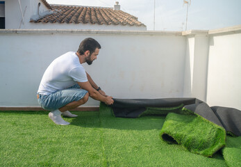 man installing artificial grass