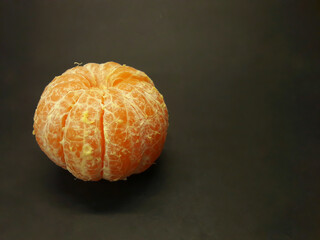 peeled citrus fruits on a black background