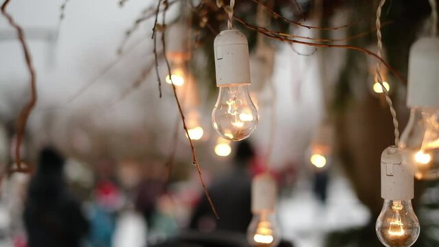 Festive garland of glowing light bulbs. Evening party lighting.