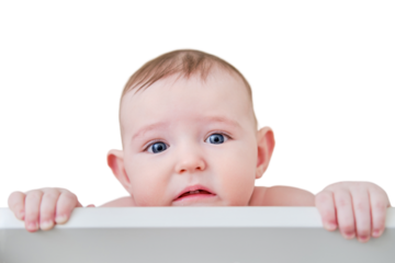 A sad baby standing in a crib, isolated on a white background. Funny child in bed, age six months