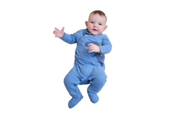 Happy baby boy in blue clothes is lying on a striped bedspread, top view, isolated on a white background. Smiling child toddler at age six months in red bed, above