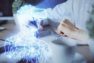 Fototapeta premium AR hologram over woman's hands taking notes background. Concept of augmented reality. Multi exposure