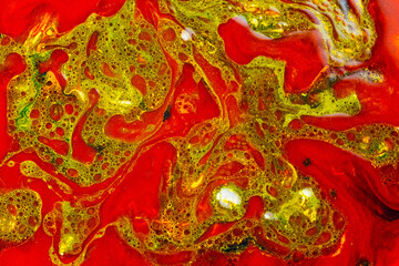 Fluid art colorful abstract background. Red-green stains of paint on liquid