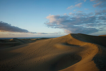 Fototapeta na wymiar Sunrise in dunes with sea in the background