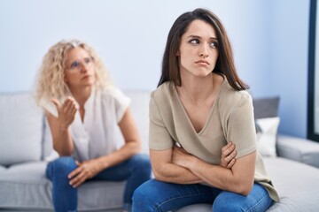 Two women mother and daughter arguing at home