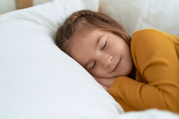 Obraz na płótnie Canvas Adorable hispanic girl lying on bed sleeping at bedroom