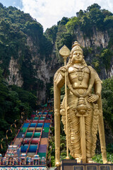 Fototapeta premium Lord Murugan Hindu statue and stairs in Batu Caves Kuala Lumpur Malaysia