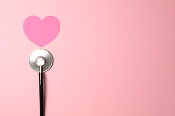 stethoscope on pink background top view, health background