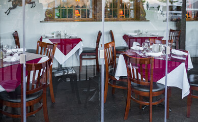 Empty outdoor restaurant table in local town. Served table at summer terrace cafe.