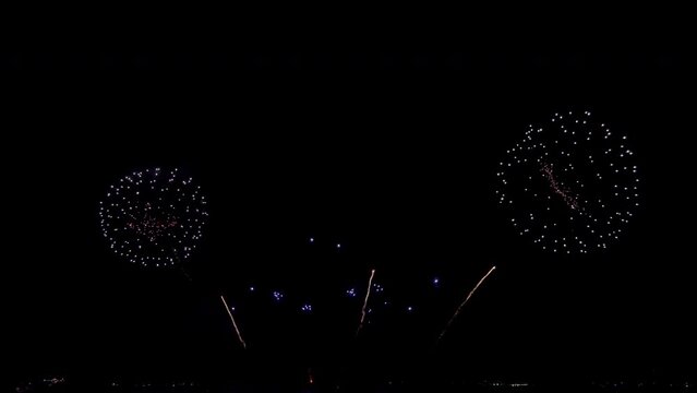 Amazing beautiful colorful firework display over sea on celebration night. Fireworks show for happy new year, 4k footage.