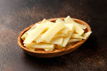 Sliced canned bamboo shoots in wooden bowl