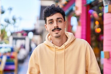 Fototapeta premium Young caucasian man smiling confident standing at street