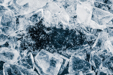 Ice cubes crush on black background. Chill backdrop. Frame border, made of ice.
