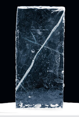 Rectangular ice block, with cracks, isolated on black background.