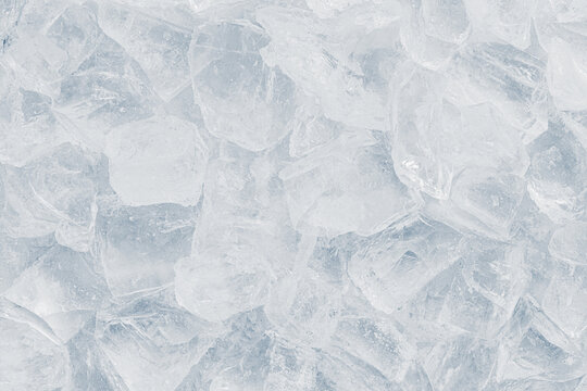 Natural crystal clear heap of crushed ice, ice cubes on the white surface background.