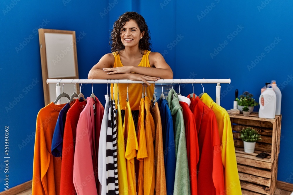Canvas Prints young latin woman smiling confident leaning on clothes rack at laundry room - Canvas Prints