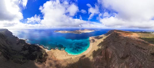 Poster Stunning nature of volcanic Lanzarote . Canary islands scenic sea  landscape View from Mirador del Rio, aerial drone panoramic view © Freesurf